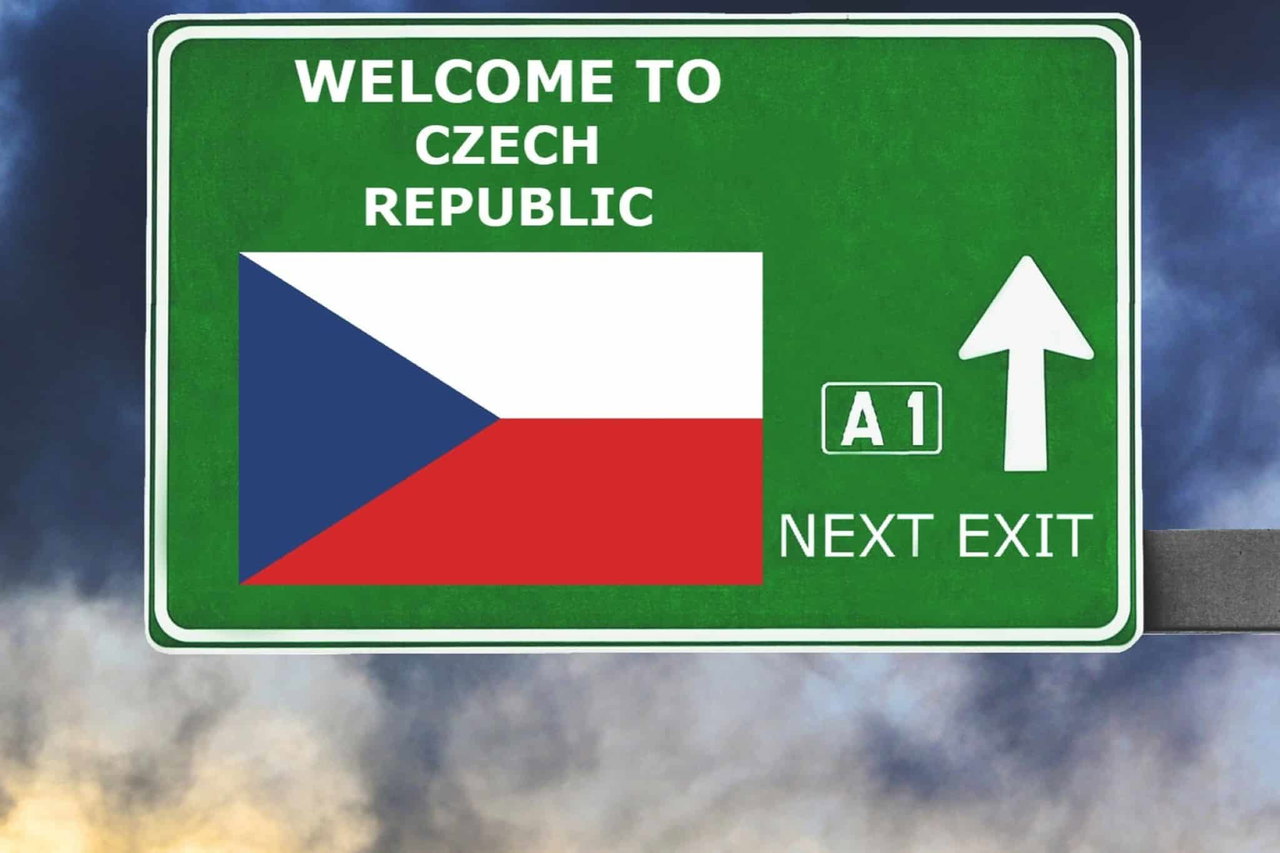 a green sign with a flag and arrow